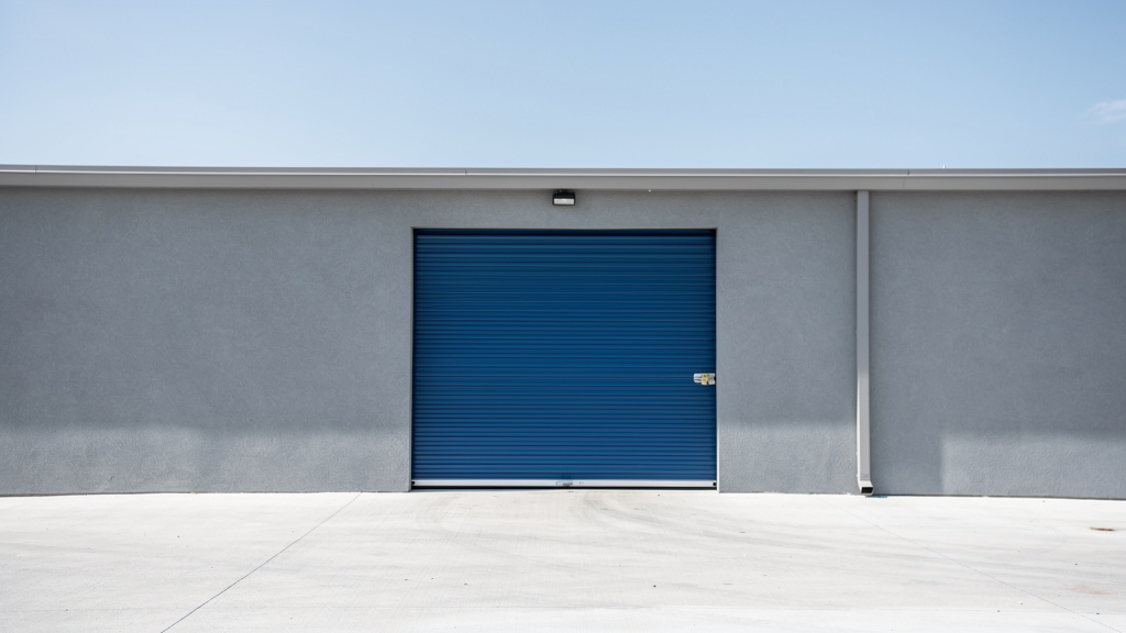 Exterior drive-up storage unit with a closed door and clear loading area