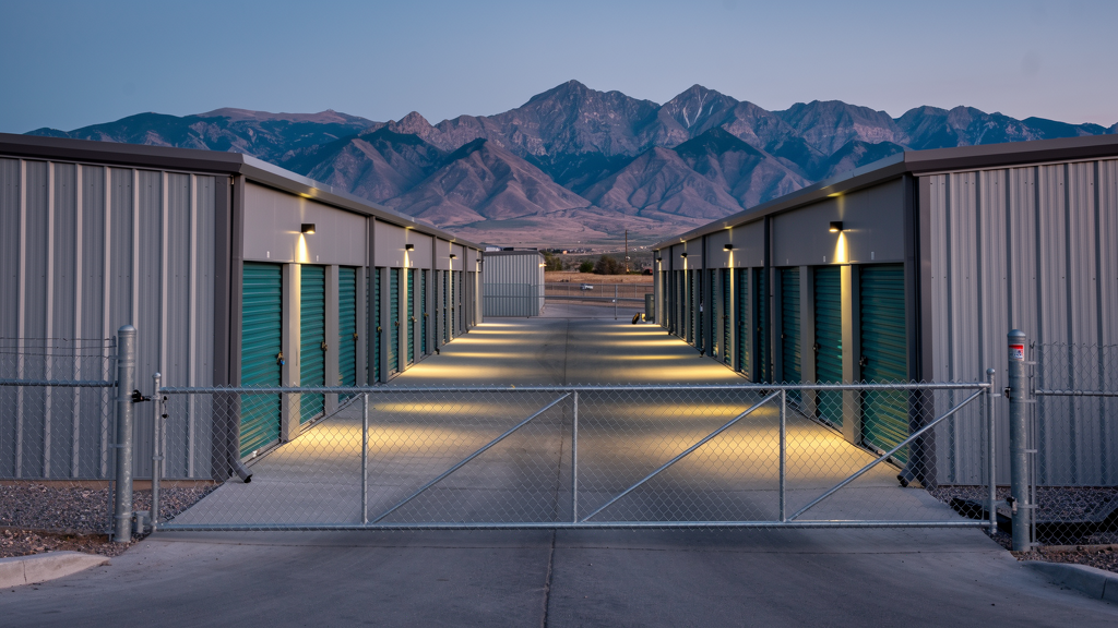 Lit fenced storage facility with coded gate after hours