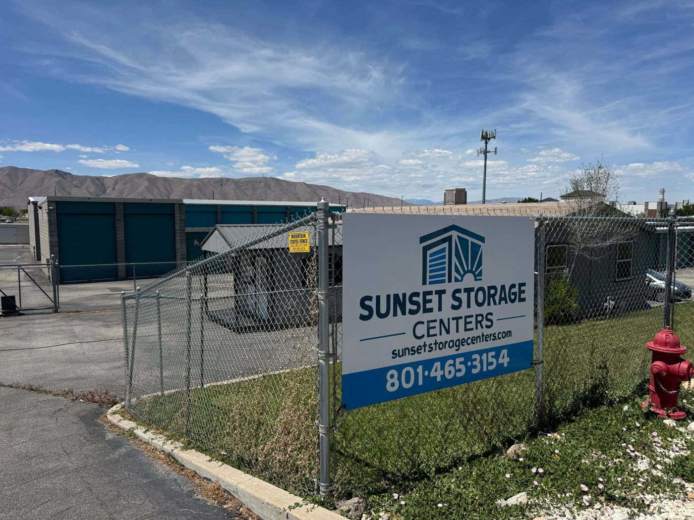 Sunset Storage Centers entrance with the facility sign, fence and gate in Payson, Utah